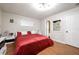 Cozy bedroom with a red bed and bright white trim at 874 Brevard Ct, Orlando, FL 32822