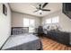 Cozy bedroom featuring wood flooring, windows with blinds, and overhead fan at 874 Brevard Ct, Orlando, FL 32822