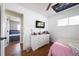 Inviting bedroom with white dresser, wood floors, and easy access to an adjoining room at 874 Brevard Ct, Orlando, FL 32822