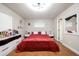 Bright bedroom with red bedding, stylish vanity, and ample natural light at 874 Brevard Ct, Orlando, FL 32822