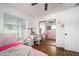 Bedroom with wood floors, a large mirror, and a window providing natural light and a spacious feel at 874 Brevard Ct, Orlando, FL 32822