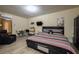 Comfortable bedroom with wood-look flooring, small table and chairs, and ample closet space at 874 Brevard Ct, Orlando, FL 32822