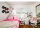 Bright bedroom featuring a desk, natural light, and pink accents for a cozy and vibrant atmosphere at 874 Brevard Ct, Orlando, FL 32822