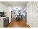Open concept dining area adjacent to modern kitchen with wood look floors at 874 Brevard Ct, Orlando, FL 32822