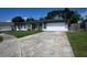 A well maintained one-story home, with a wide driveway, and fresh landscaping at 874 Brevard Ct, Orlando, FL 32822