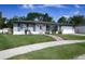 A quaint one-story home with lush green lawn, brick walkway, and charming curb appeal at 874 Brevard Ct, Orlando, FL 32822