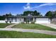 Charming single-story home with a well-manicured lawn and a welcoming brick pathway at 874 Brevard Ct, Orlando, FL 32822