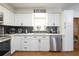 Kitchen with stainless steel appliances, white cabinets, and a decorative backsplash at 874 Brevard Ct, Orlando, FL 32822