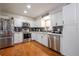 Bright kitchen features stainless steel appliances, white cabinets, and stylish backsplash at 874 Brevard Ct, Orlando, FL 32822