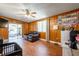 Living room featuring wood paneling, a sliding glass door, and tile flooring at 874 Brevard Ct, Orlando, FL 32822