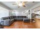 Spacious living room with a large gray sofa, textured wall, and an open flow to the kitchen at 874 Brevard Ct, Orlando, FL 32822