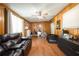 Living area with wooden walls and a comfortable leather sofa at 874 Brevard Ct, Orlando, FL 32822