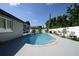 Backyard pool with a patio, complemented by a lush garden and tranquil blue skies at 874 Brevard Ct, Orlando, FL 32822