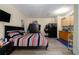 Cozy studio apartment with a bed, kitchenette, and wood-look flooring at 874 Brevard Ct, Orlando, FL 32822