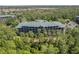 Scenic aerial view of a well-maintained condominium complex surrounded by lush greenery at 9051 Treasure Trove Ln # 505, Kissimmee, FL 34747