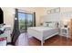 Bedroom featuring a queen bed, wood floors, and a sliding glass door at 9051 Treasure Trove Ln # 505, Kissimmee, FL 34747