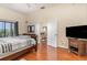 Bright bedroom with access to the balcony, a dresser and television, and access to the living room at 9051 Treasure Trove Ln # 505, Kissimmee, FL 34747