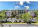 Exterior view of a spacious condo complex with ample parking and mature trees at 9051 Treasure Trove Ln # 505, Kissimmee, FL 34747
