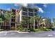 A condo building featuring outdoor screened-in patios with landscaped grounds at 9051 Treasure Trove Ln # 505, Kissimmee, FL 34747
