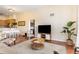 Bright living room with hardwood floors, comfortable seating and seamless access to the kitchen at 9051 Treasure Trove Ln # 505, Kissimmee, FL 34747