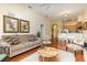 Open-concept living room with hardwood floors and a dining area and kitchen in the background at 9051 Treasure Trove Ln # 505, Kissimmee, FL 34747