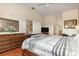 Spacious main bedroom with a dresser and television, and a view through to the bathroom at 9051 Treasure Trove Ln # 505, Kissimmee, FL 34747