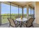 Relaxing screened-in patio with a table and chairs, overlooking a lush landscape at 9051 Treasure Trove Ln # 505, Kissimmee, FL 34747