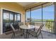 Relaxing screened-in patio with a table and chairs, and a scenic view at 9051 Treasure Trove Ln # 505, Kissimmee, FL 34747