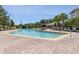Community pool with brick paver patio and comfortable lounge chairs at 9051 Treasure Trove Ln # 505, Kissimmee, FL 34747