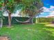 Serene backyard with a hammock strung between trees, offering a peaceful retreat at 9942 Hatton Cir, Orlando, FL 32832