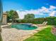 Secluded backyard pool surrounded by lush greenery, chaise lounges, fire pit, and mature trees at 9942 Hatton Cir, Orlando, FL 32832