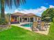 Inviting backyard boasts a sparkling pool, covered lounge area, and elegant patio seating at 9942 Hatton Cir, Orlando, FL 32832