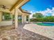 Spacious backyard featuring a pool, covered patio, and well-manicured landscaping for outdoor enjoyment at 9942 Hatton Cir, Orlando, FL 32832
