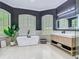 Contemporary bathroom featuring freestanding tub, double vanities and bright lighting at 9942 Hatton Cir, Orlando, FL 32832