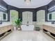 Bright bathroom featuring dual vanities, a freestanding tub, and modern decor at 9942 Hatton Cir, Orlando, FL 32832