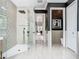 Spacious bathroom showing off a glass-enclosed shower with a black shower system and a view to the hall at 9942 Hatton Cir, Orlando, FL 32832