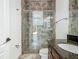 Bathroom showcasing a glass shower with tile, a dark wood vanity, and a toilet at 9942 Hatton Cir, Orlando, FL 32832