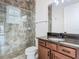 Bathroom featuring a glass shower with tile, a dark wood vanity, and a modern sink at 9942 Hatton Cir, Orlando, FL 32832
