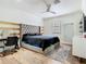 Stylish bedroom featuring a tufted headboard, modern fan, and a dedicated vanity area at 9942 Hatton Cir, Orlando, FL 32832