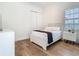 Bright bedroom features hardwood floors, a window with plantation shutters, and a modern bed at 9942 Hatton Cir, Orlando, FL 32832