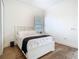 Bedroom featuring hardwood floors, a window with plantation shutters, and a modern bed at 9942 Hatton Cir, Orlando, FL 32832