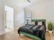 Bright bedroom featuring modern flooring, closet, neutral paint, and en-suite access at 9942 Hatton Cir, Orlando, FL 32832