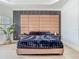 Modern bedroom showcasing accent wall, and a luxuriously padded headboard at 9942 Hatton Cir, Orlando, FL 32832