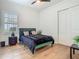 Bright bedroom featuring modern flooring, closet, neutral paint, and window at 9942 Hatton Cir, Orlando, FL 32832