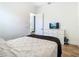 Bedroom features hardwood floors, white walls, and a TV atop a white dresser at 9942 Hatton Cir, Orlando, FL 32832