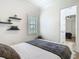 Bright bedroom featuring modern flooring, shelving, neutral paint, and window at 9942 Hatton Cir, Orlando, FL 32832