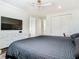 Bedroom featuring modern fan, dresser, and dark bedding, creating a serene atmosphere at 9942 Hatton Cir, Orlando, FL 32832