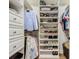 Organized walk-in closet featuring built-in shelving and hanging space at 9942 Hatton Cir, Orlando, FL 32832