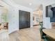 Bright foyer features elegant double doors, hardwood floors, and views into the home's open-concept living spaces at 9942 Hatton Cir, Orlando, FL 32832