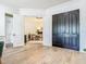 Light-filled foyer shows home office through doorway with dark double doors and light hardwood flooring at 9942 Hatton Cir, Orlando, FL 32832